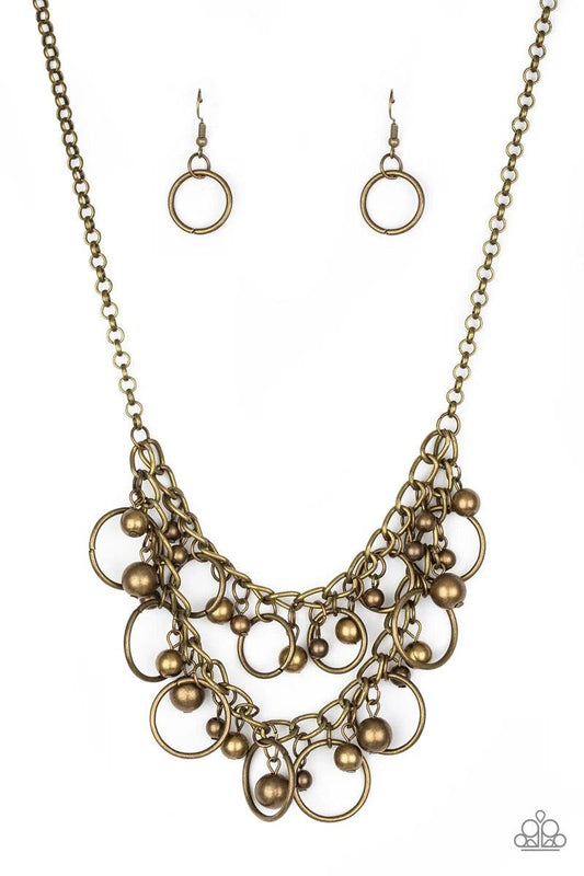 Paparazzi Accessories Warning Bells - Brass Brushed in an antiqued finish, mismatched brass beads and airy brass hoops swing from two rows of brass chains, creating an edgy fringe below the collar. Features an adjustable clasp closure. Sold as one individ