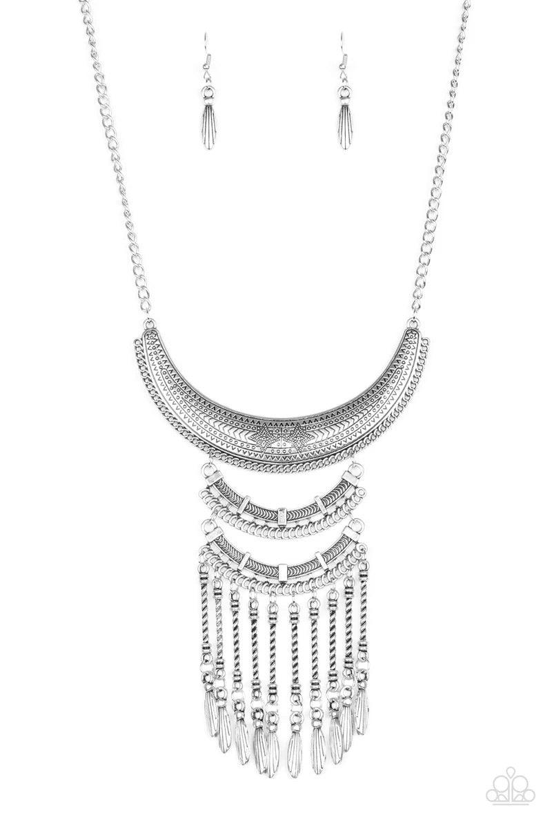 Paparazzi Accessories Eastern Empress - Silver Stamped and embossed in tribal inspired patterns, three silver plates connect down the chest, creating a fiercely stacked pendant. Attached to twisted silver rods, ornate silver beads swing from the bottom of