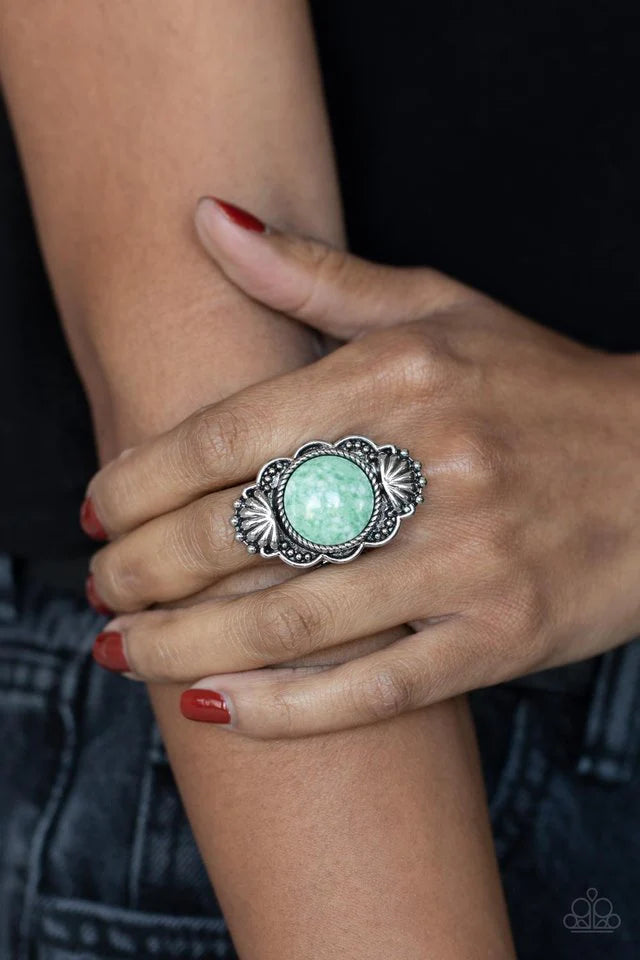 Paparazzi Accessories Atlantis Adventure - Green Adorned in silver seashells and dainty silver studs, the center of a scalloped silver frame is dotted with an oversized green stone for an artisan inspired finish. Features a stretchy band for a flexible fi