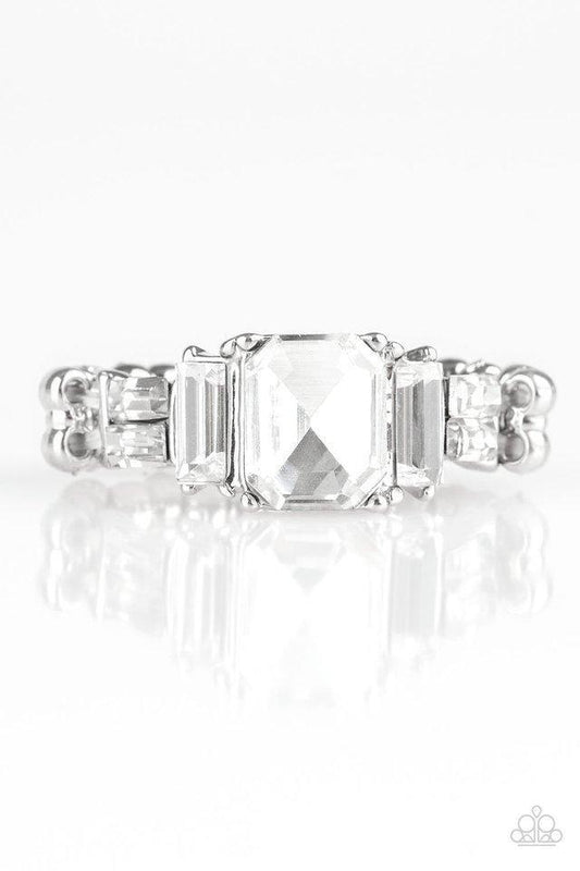 Paparazzi Accessories Born to Rule - White Varying in cut and shimmer, glittery white rhinestones stack into a glamorous band across the finger. Features a dainty stretchy band for a flexible fit.Sold as one individual ring. Jewelry