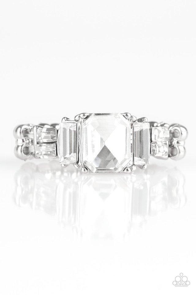 Paparazzi Accessories Born to Rule - White Varying in cut and shimmer, glittery white rhinestones stack into a glamorous band across the finger. Features a dainty stretchy band for a flexible fit.Sold as one individual ring. Jewelry