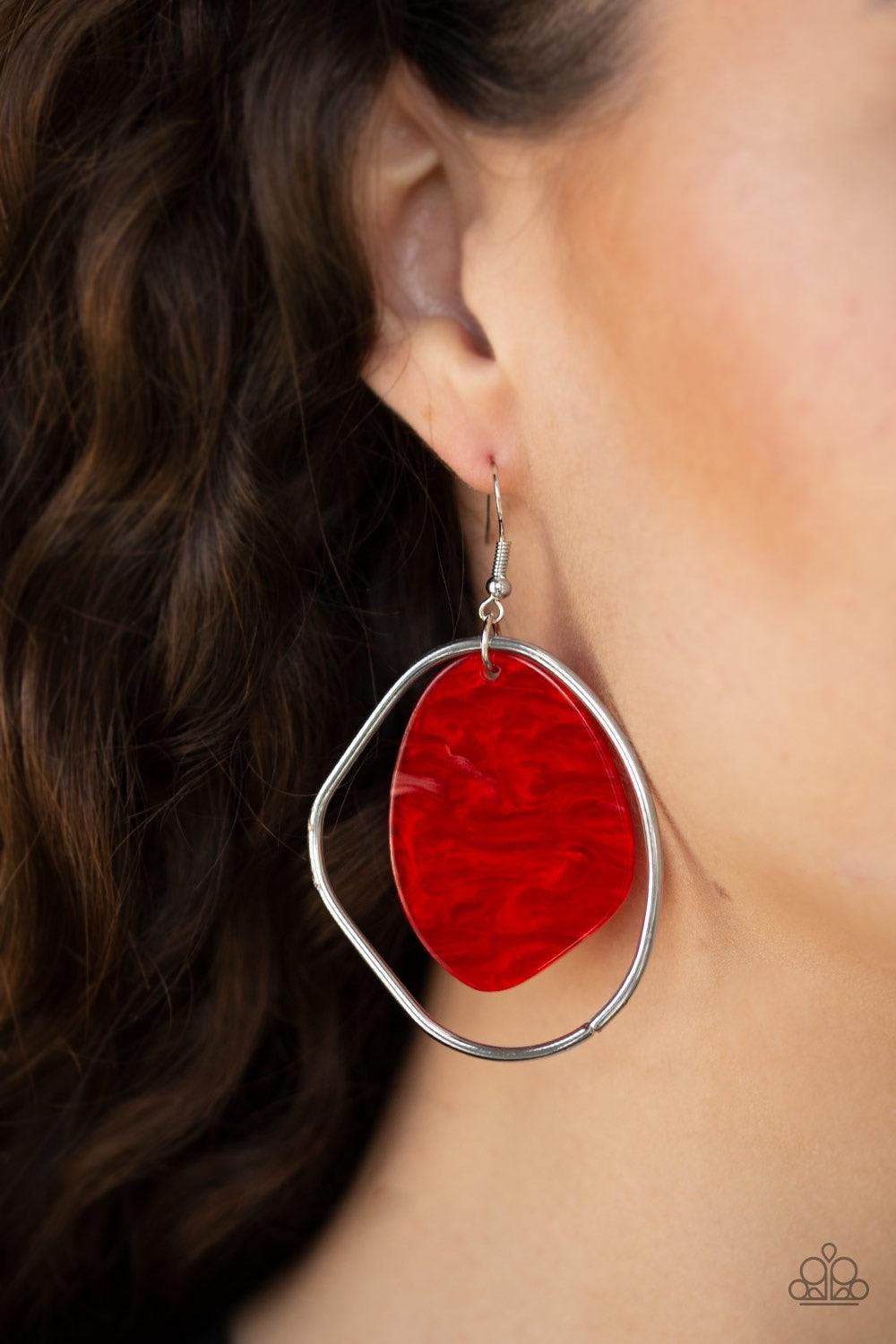Paparazzi Accessories HAUTE Toddy - Red Brushed in a red shell-like iridescence, an abstract acrylic frame swings from the top of an asymmetrical silver hoop for a seasonal flair. Earring attaches to a standard fishhook fitting. Jewelry