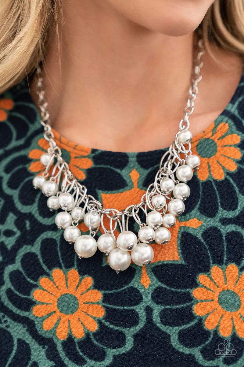 Paparazzi Accessories Powerhouse Pose - White Oversized white pearls dance from the bottoms of shiny silver ovals that delicately cluster along a chunky silver chain, resulting in a luxurious fringe below the collar. Features an adjustable clasp closure.