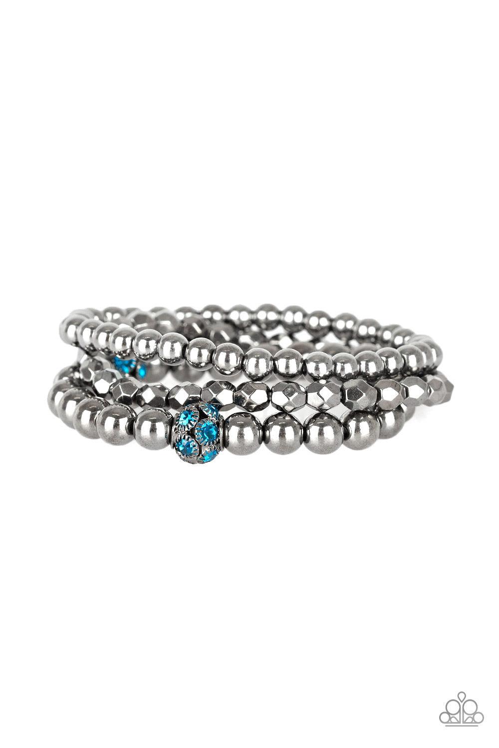 Paparazzi Accessories Noticeably Noir - Blue Mismatched gunmetal beads and blue rhinestone encrusted beads are threaded along stretchy bands for an edgy and refined look. Sold as one set of three bracelets. Jewelry