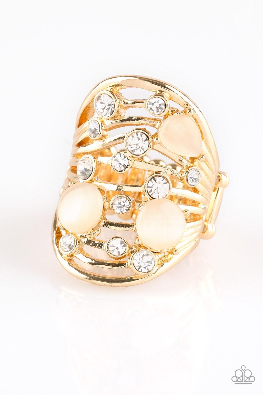 Paparazzi Accessories Clear The SWAY - Gold Glistening gold bars sway across the finger, coalescing into an airy band. Glittery white rhinestones and glowing moonstones are sprinkled along the wavy bands for a refined finish. Features a stretchy band for