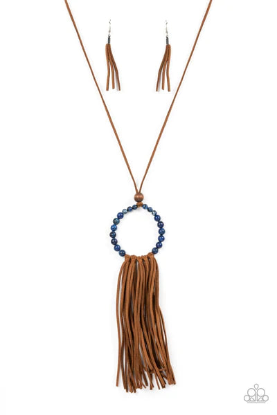 Paparazzi Accessories Namaste Mama - Blue A collection of refreshing lapis lazuli stone beads are threaded around a wire hoop that is fastened at the end of a lengthened brown suede cord. The earthy stones make way for a foxy fringe of brown suede that sw