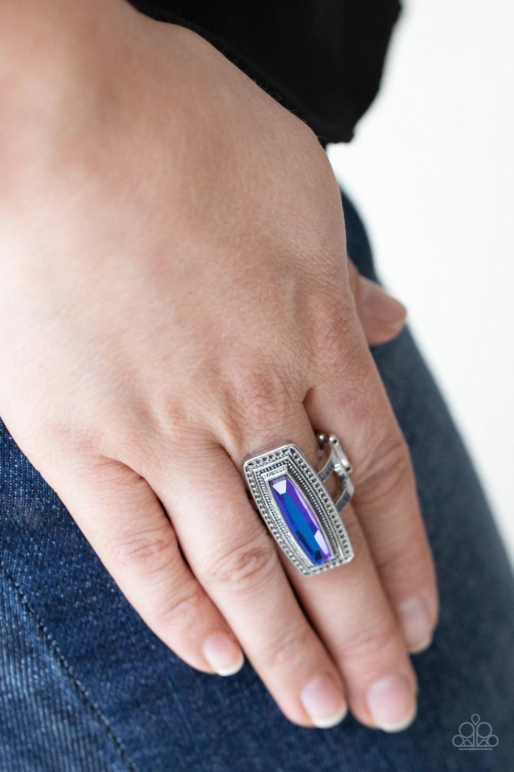 Paparazzi Accessories Luminary Luster - Blue An elongated UV gem is pressed into the center of a studded silver frame atop layered silver bands, creating a stellar centerpiece atop the finger. Features a stretchy band for a flexible fit. Sold as one indiv