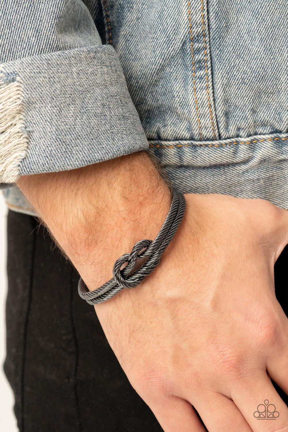 Paparazzi Accessories Nautical Grunge - Black Gritty gunmetal cable-like bars curl around the wrist, knotting into an edgy cuff for a bold industrial look. Sold as one individual bracelet. Jewelry