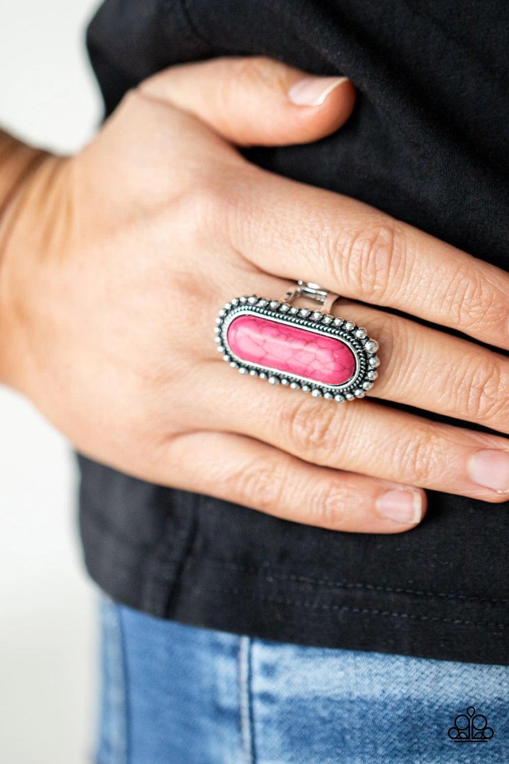 Paparazzi Accessories Sedona Scene - Pink An oblong pink stone is nestled inside an oversized studded silver frame, creating a colorfully rustic centerpiece atop the finger. Features a stretchy band for a flexible fit. Sold as one individual ring. Rings