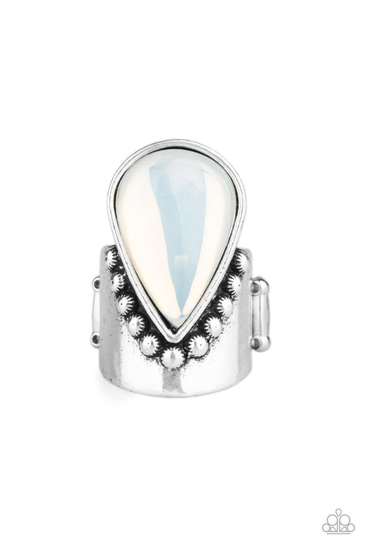 Paparazzi Accessories Opal Mist - White Featuring a milky iridescence, the tip of a glassy white teardrop attaches to a studded silver band. The bottom of the ethereal teardrop drips down towards the knuckle, creating a bold, one-of-a-kind statement piece