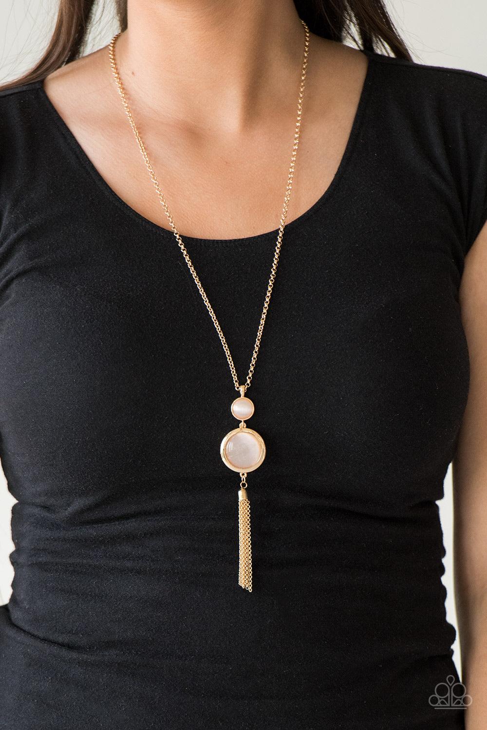 Paparazzi Accessories Have Some Common SENSEI - Gold Swinging from the bottom of a glistening gold chain, glowing stacked moonstone pendants give way to a shimmery gold tassel for a refined look. Features an adjustable clasp closure. Sold as one individua