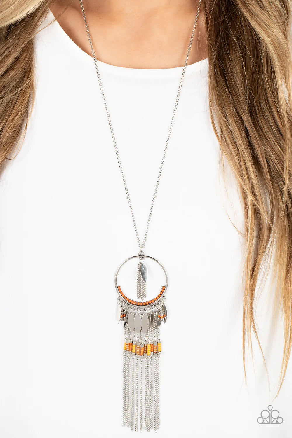 Paparazzi Accessories Dancing Dreamcatcher - Orange Leafy silver charms dangle from the bottom of an orange beaded silver hoop. The colorful pendant gives way to a silver chain fringe adorned in silver cube beads and yellow, coral, and pearly brown seed b