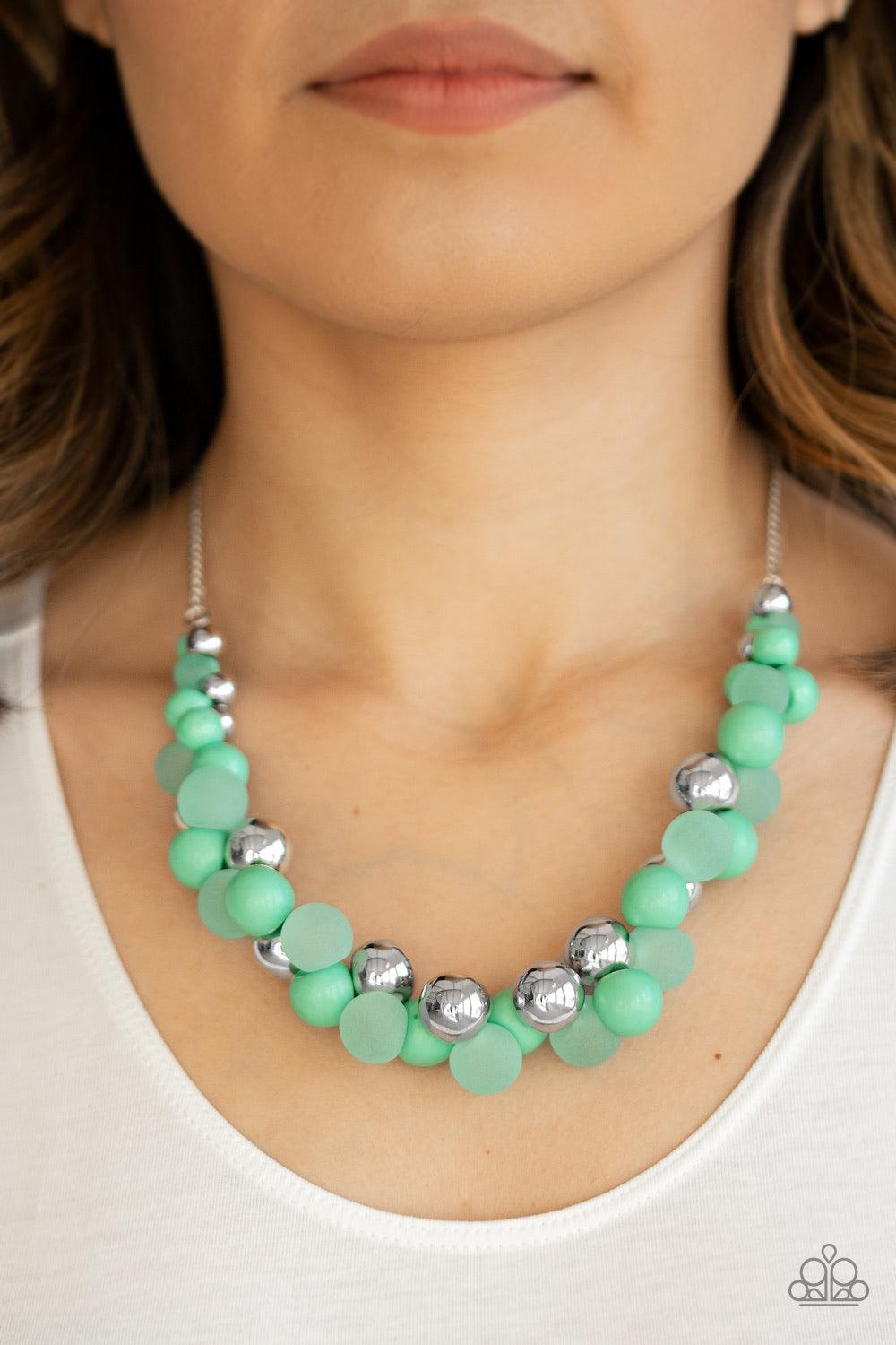 Paparazzi Accessories Bubbly Brilliance - Green A bubbly collection of imperfect silver, opaque, and Biscay Green beads are threaded along an invisible wire below the collar, creating a colorful cluster. Features an adjustable clasp closure. Jewelry