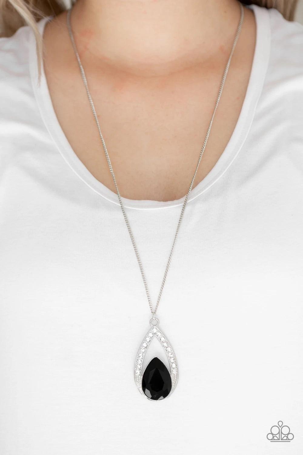 Paparazzi Accessories Notorious Noble - Black A glittery black teardrop gem is pressed into a silver frame radiating with glassy white rhinestones. The glamorous pendant swings from the bottom of a shimmery silver chain for a refined look. Features an adj