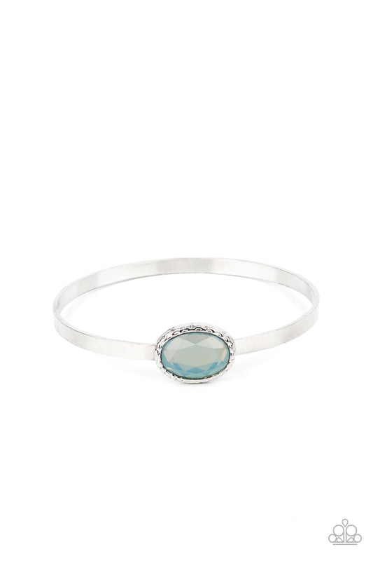 Paparazzi Accessories Misty Meadow - Blue A misty blue gem is pressed into the center of a hammered silver fitting atop a thick silver bangle, creating an ethereal centerpiece. Sold as one individual bracelet. Jewelry