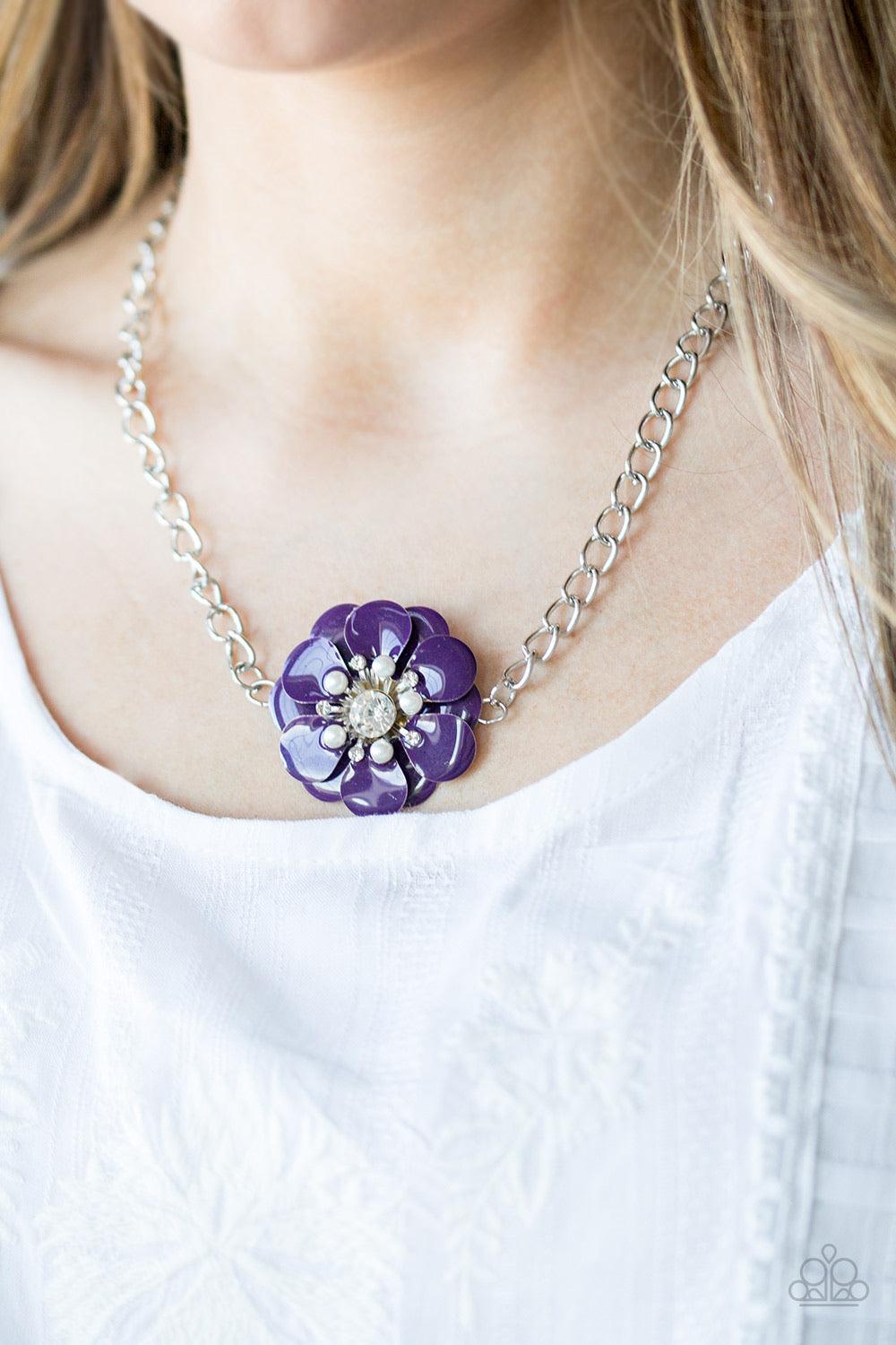 Paparazzi Accessories Hibiscus Hula - Purple Painted in a shiny purple finish, overlapping petals bloom below the collar. Dainty white pearls and glittery white rhinestones are encrusted around the center of the floral pendant for a whimsical finish. Feat