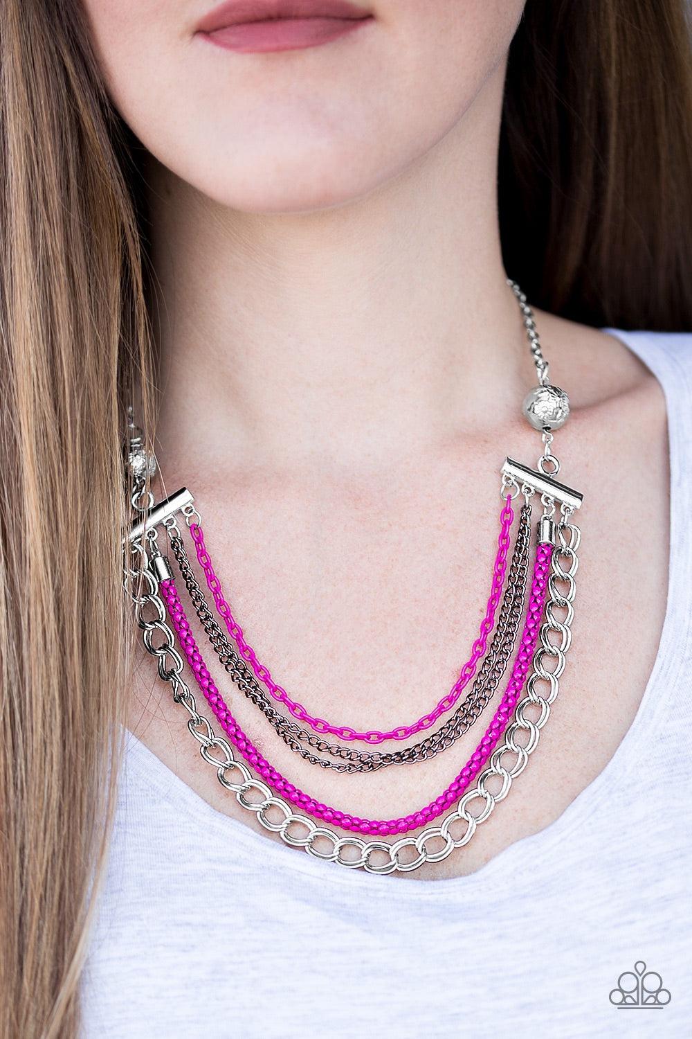 Paparazzi Accessories High-Intensity - Pink Two floral silver beads give way to an array of pink, gunmetal, and silver chains. Strung between two metal beads, the mismatched chains layer below the collar in a colorfully industrial fashion. Features an adj