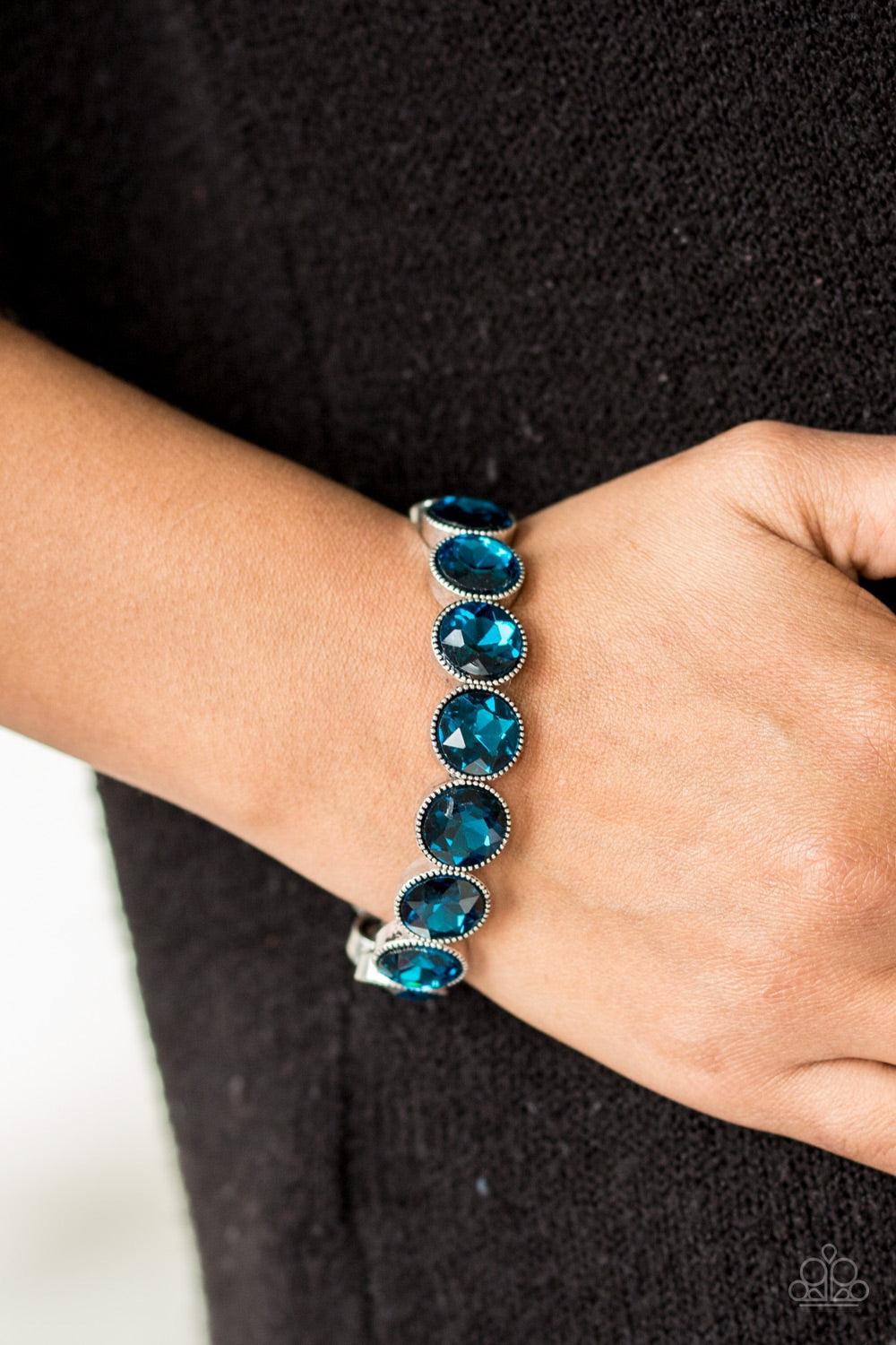 Paparazzi Accessories Number One Knockout - Blue Faceted blue gems are pressed into sleek silver frames. The glittery frames are threaded along elastic stretchy bands, creating a glamorous look around the wrist. Jewelry