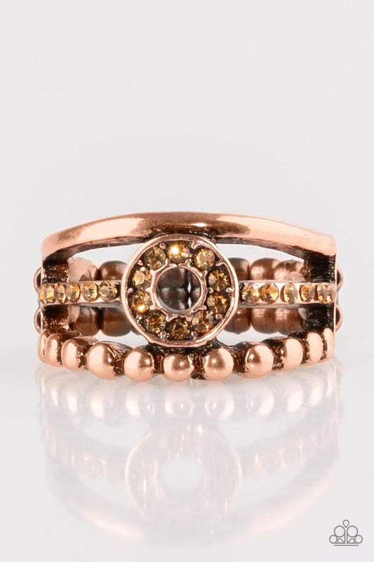 Paparazzi Accessories Cost of Living - Copper A smooth and dotted copper band flank a topaz rhinestone encrusted band, creating glittery layers across the finger. Encrusted in golden topaz rhinestones, a circular frame is pressed into the center of the ba