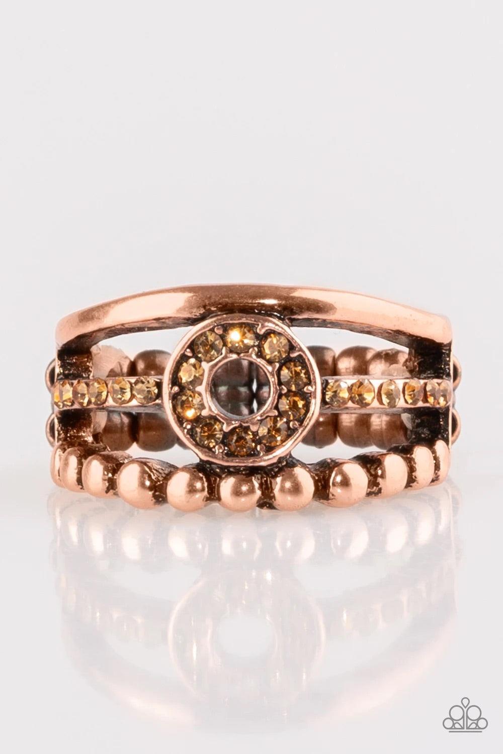 Paparazzi Accessories Cost of Living - Copper A smooth and dotted copper band flank a topaz rhinestone encrusted band, creating glittery layers across the finger. Encrusted in golden topaz rhinestones, a circular frame is pressed into the center of the ba