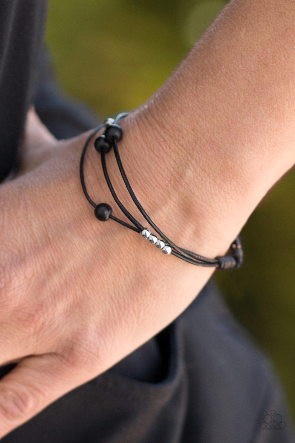 Paparazzi Accessories Mountain Treasure - Black Shiny silver beads and refreshing white stones are threaded along shiny black cording, creating dainty layers across the wrist. Features an adjustable sliding knot closure. Sold as one individual bracelet. J