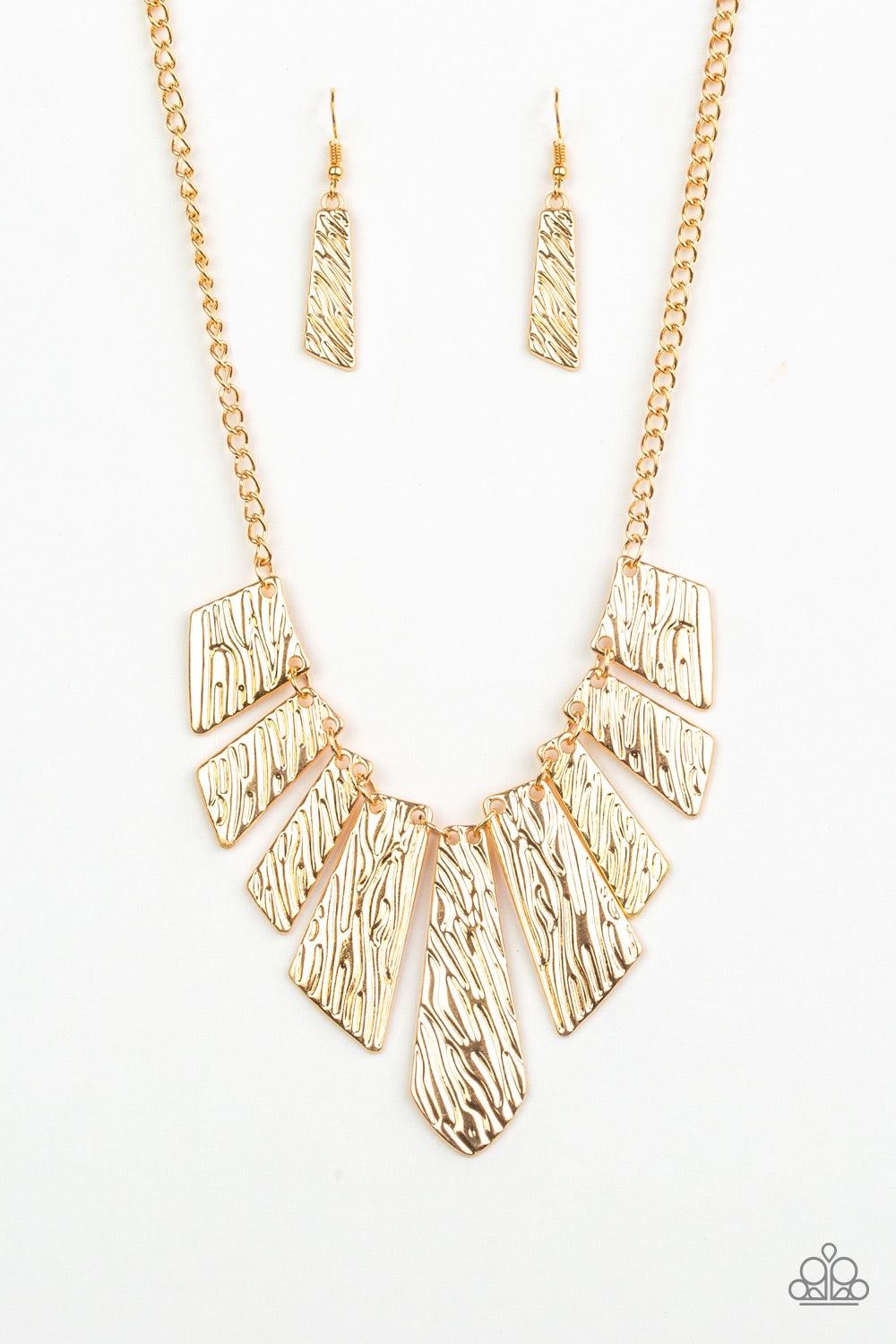 Paparazzi Accessories Texture Tigress - Gold Embossed in rippling patterns, a collection of angular gold plates swing from the bottom of a glistening gold chain, creating an edgy geometric fringe below the collar. Features an adjustable clasp closure. Jew