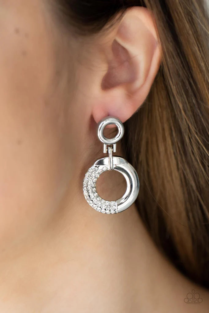 Paparazzi Accessories Modern Motivation - White A dainty silver hoop attaches to a shimmery silver ring that is half dipped in glassy white rhinestones, creating a modern look. Earring attaches to a standard post fitting. Sold as one pair of post earrings