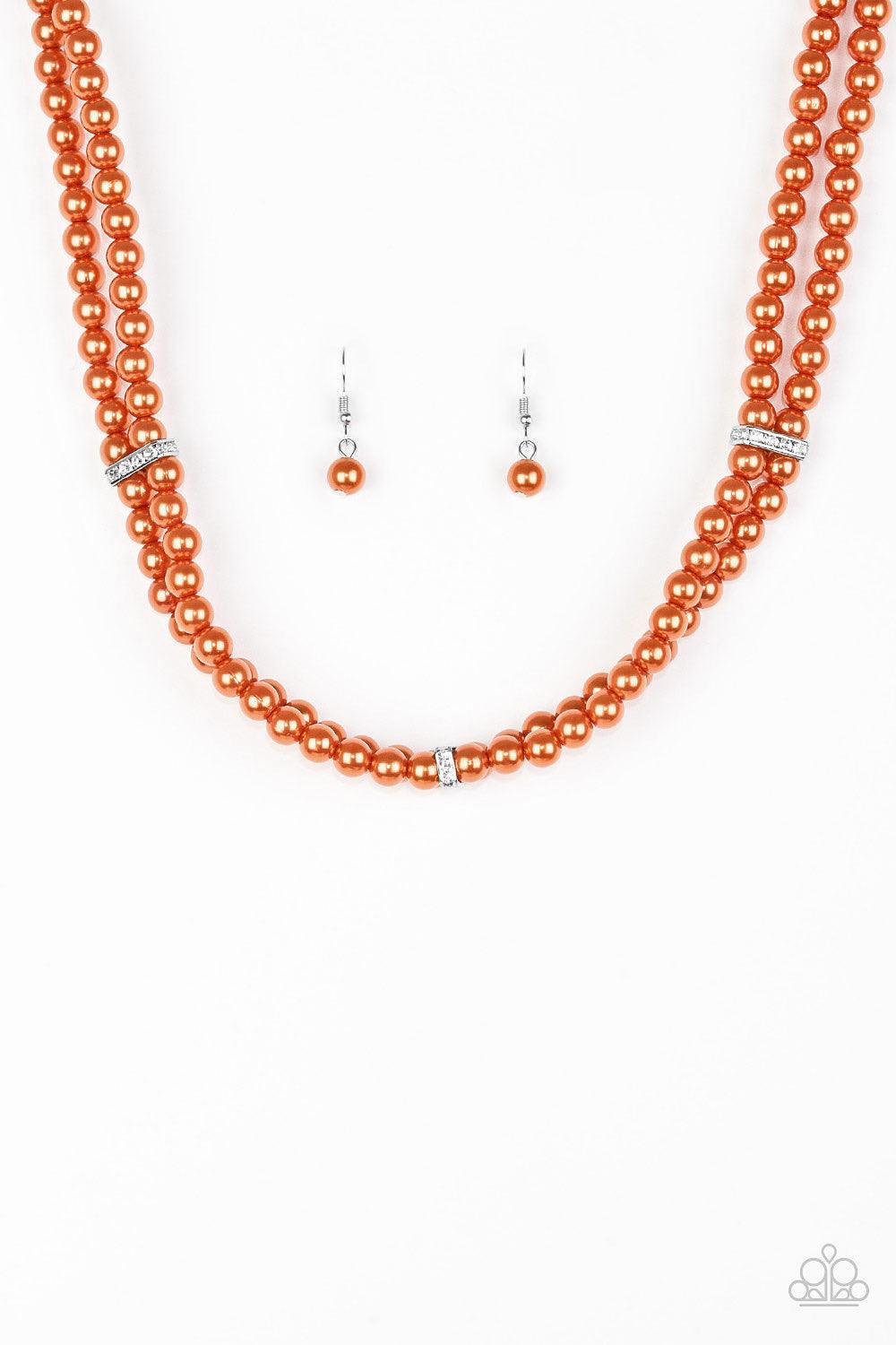 Paparazzi Accessories Put On Your Party Dress - Orange Pinched between white rhinestone encrusted frames, strands of classic orange pearls layer below the collar for a timeless look. Features an adjustable clasp closure. Jewelry