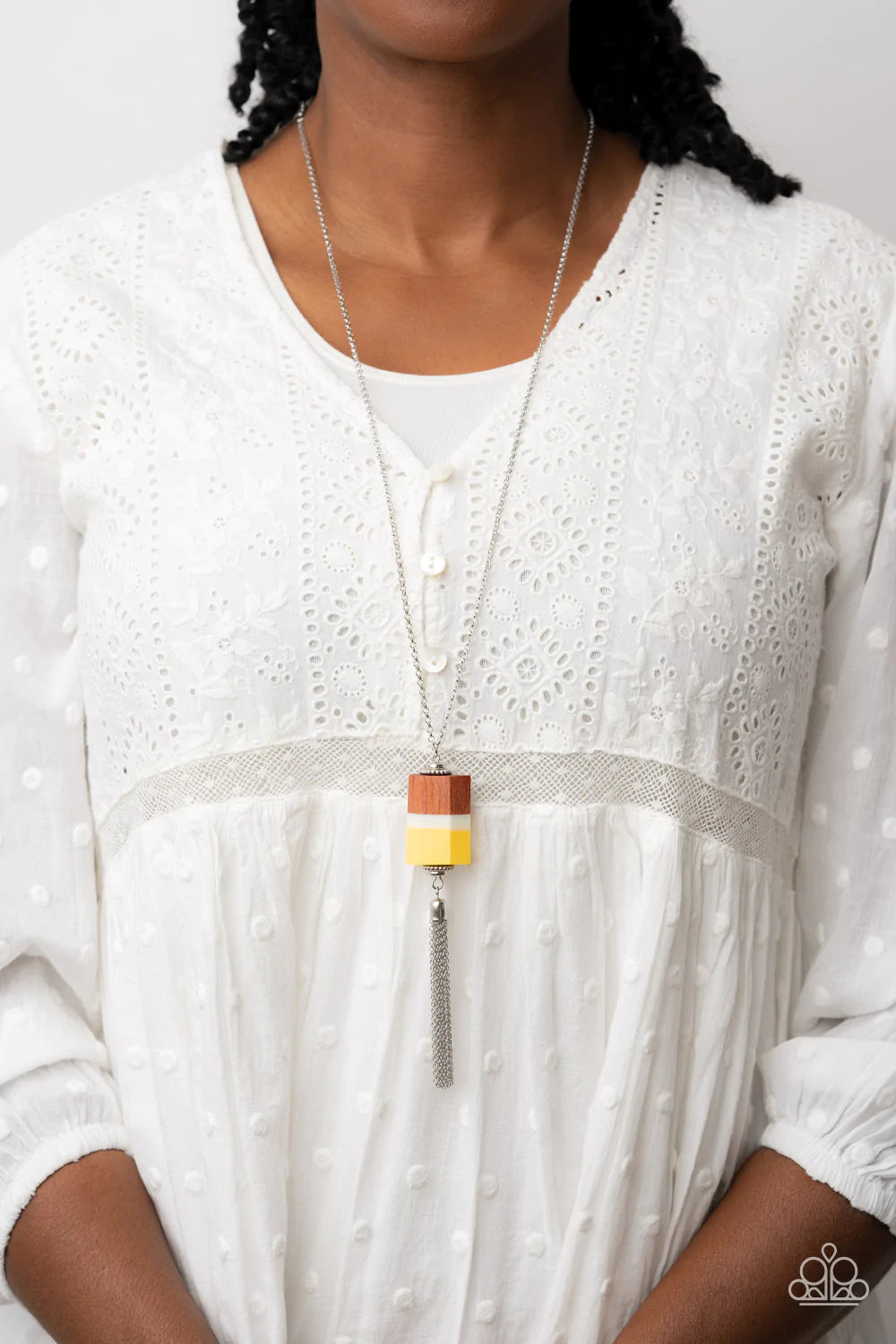 Paparazzi Accessories Reel It In - Yellow Infused with silver beaded accents, pieces of yellow and brown wood and a white acrylic accent delicately stack into a faceted geometric pendant at the bottom of an extended silver chain. A shimmery silver chain t