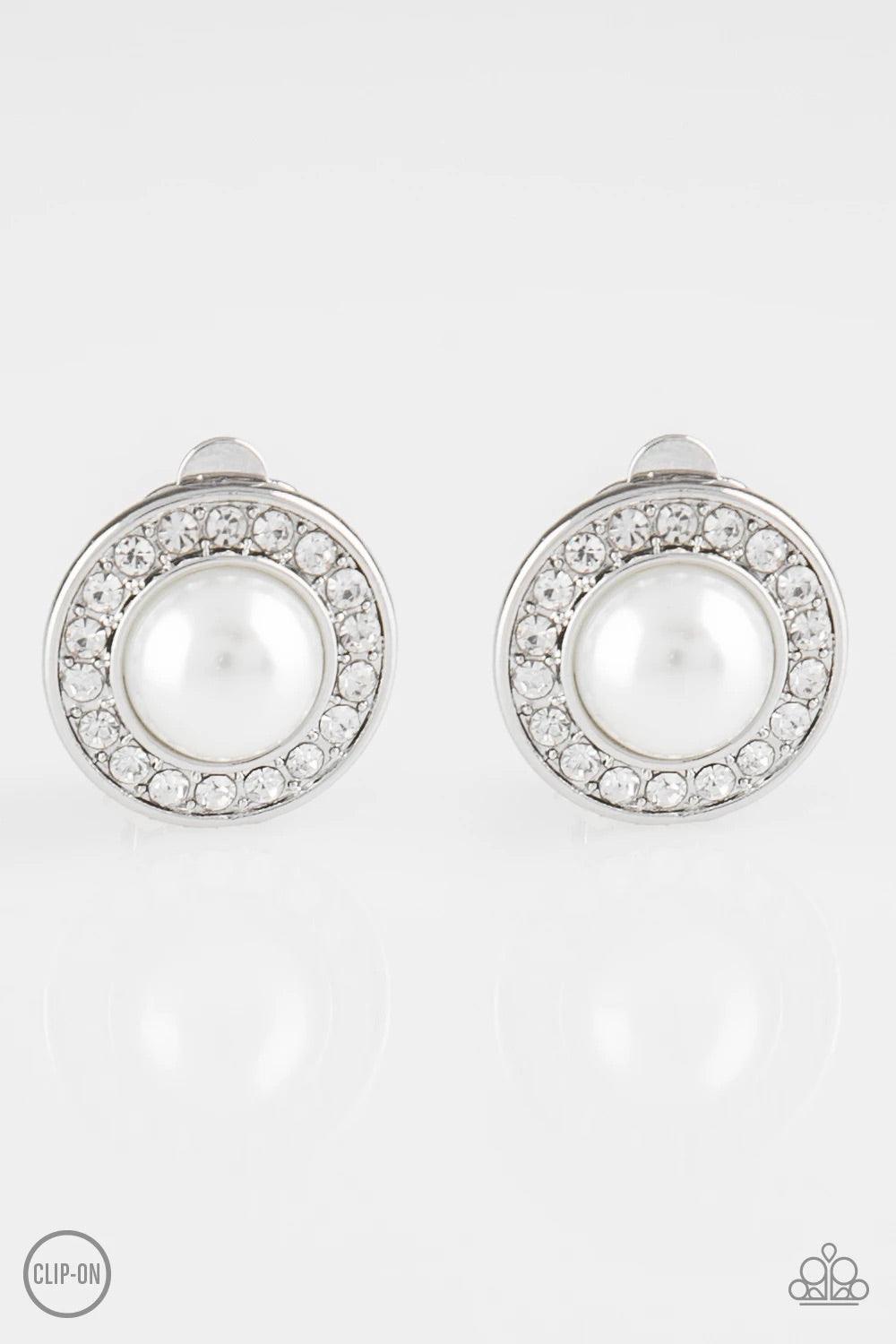 Paparazzi Accessories Definitely Dapper - White *Clip-On A ring of glassy white rhinestones spins around a white pearl-drop center for a timeless look. Earring attaches to a standard clip-on fitting. Sold as one pair of clip-on earrings. Jewelry