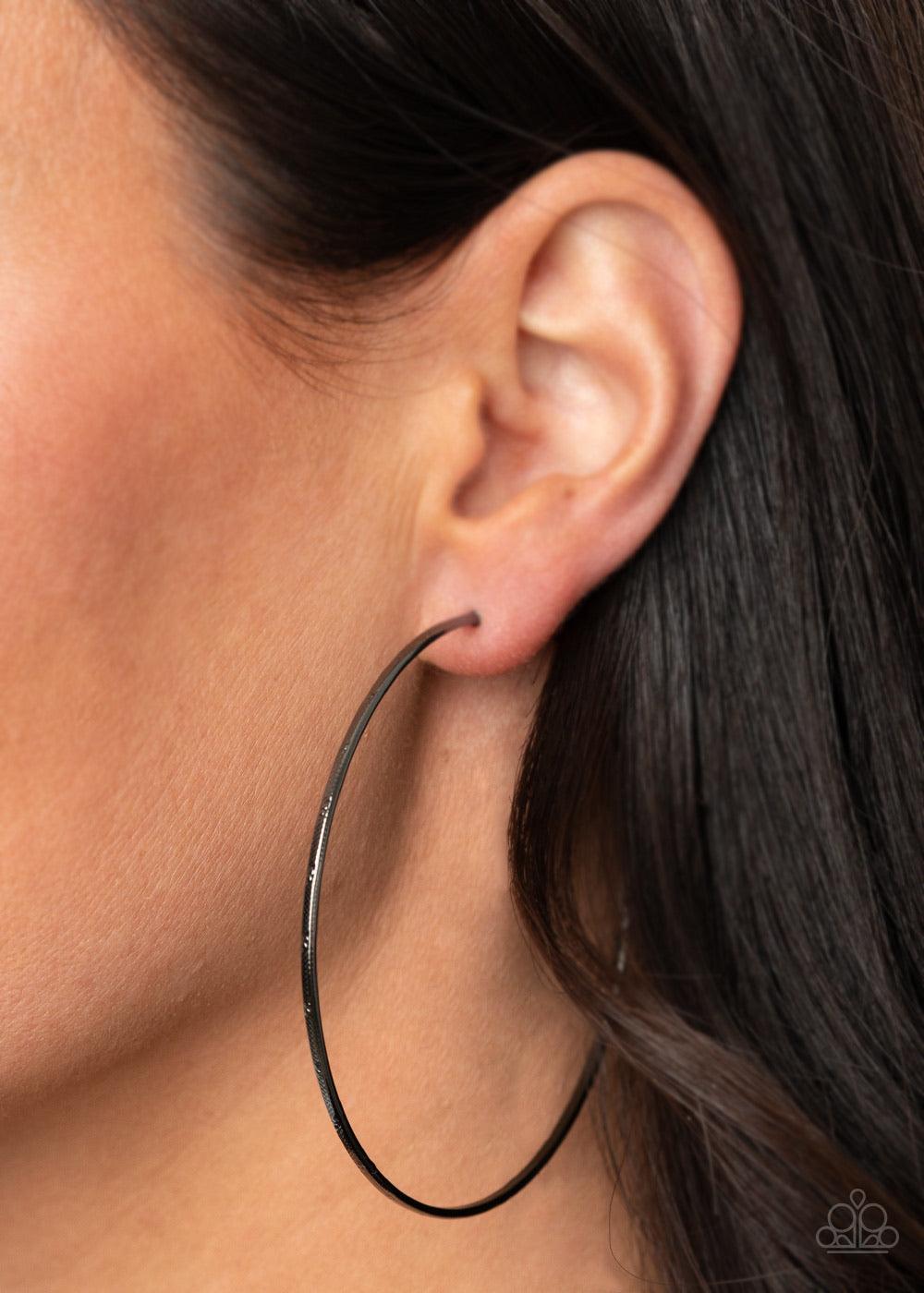 Paparazzi Accessories Very Curvaceous - Black Delicately hammered in a subtle shimmer, a glistening gunmetal wire dramatically curves into an oversized hoop for a flawless finish. Earring attaches to a standard post fitting. Hoop measures approximately 2