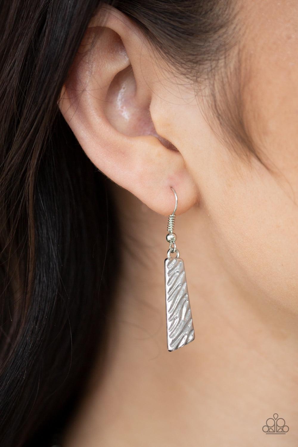 Paparazzi Accessories Texture Tigress - Silver Embossed in rippling patterns, a collection of angular silver plates swing from the bottom of a glistening silver chain, creating an edgy geometric fringe below the collar. Features an adjustable clasp closur