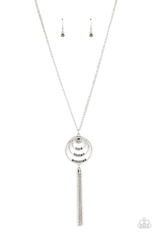 Paparazzi Accessories Spiraling Sparkle - Silver Embellished with rows of hematite rhinestones, concentric silver hoops connect into a single pendant at the bottom of a silver chain. A glistening silver chain tassel swings from the bottom of the display a