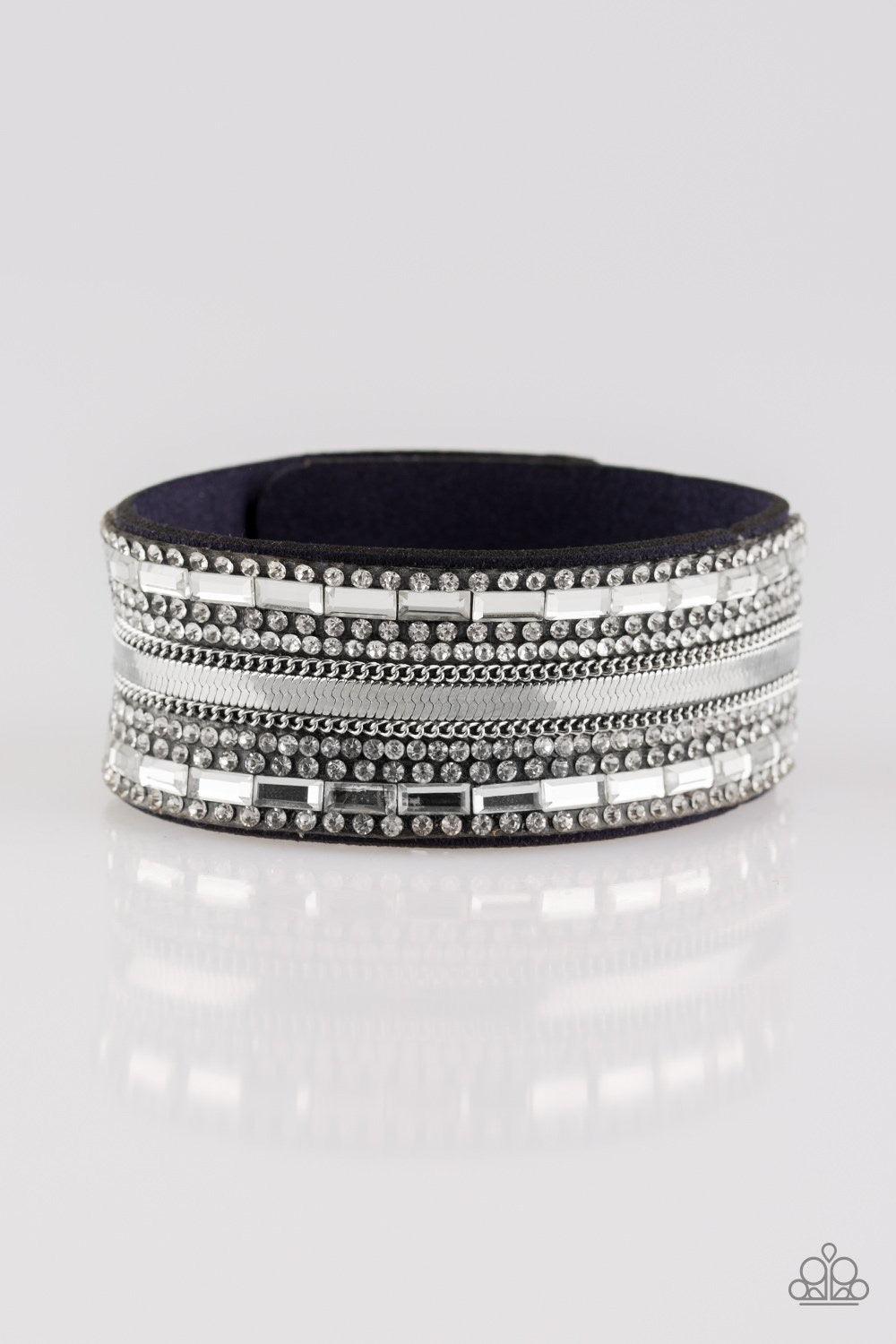 Paparazzi Accessories Teasingly Tomboy - Blue Mismatched silver chains, glassy emerald-cut, and glittery white rhinestones are encrusted along a thick blue suede band for a sassy look. Features an adjustable snap closure. Sold as one individual bracelet.
