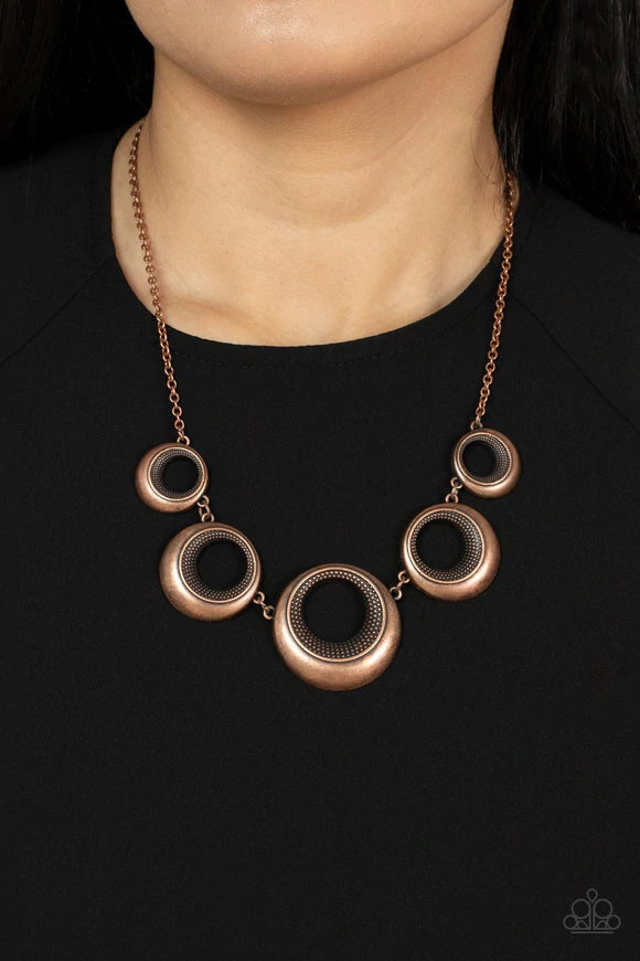 Paparazzi Accessories Solar Cycle - Copper Featuring studded centers, an antiqued collection of beveled copper hoops gradually increase in size as they link below the collar for a bold metallic look. Features an adjustable clasp closure. Sold as one indiv