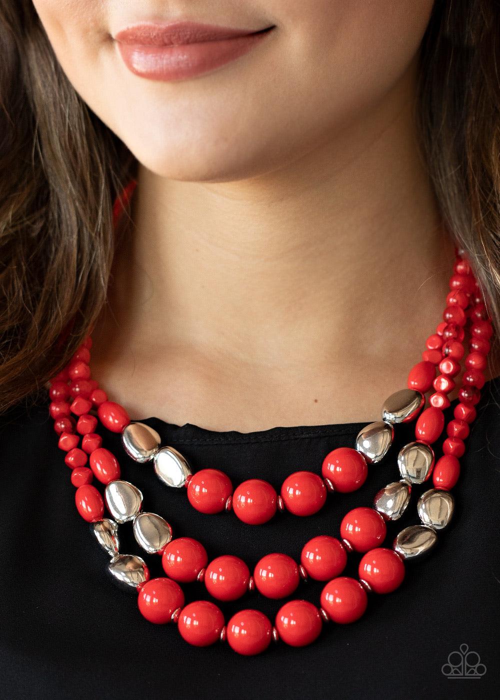 Paparazzi Accessories Flamingo Flamboyance - Red Featuring opaque and polished finishes, a mismatched collection of red and silver beads are threaded along invisible wires, creating colorful layers below the collar. Features an adjustable clasp closure. S