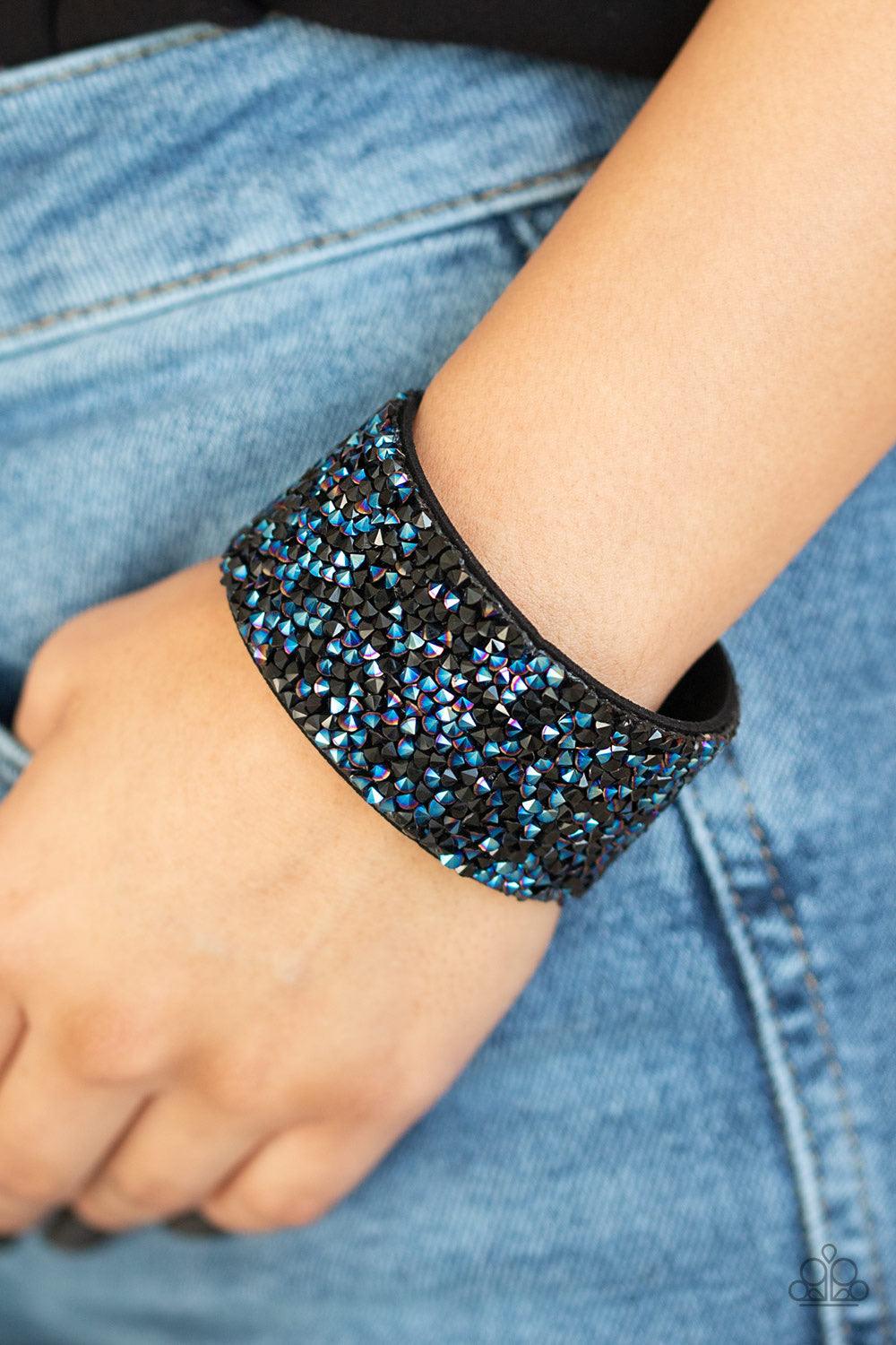 Paparazzi Accessories Rhinestone Runway - Multi Dainty black and metallic blue rhinestone prisms are sprinkled across the center of a thick black suede band, creating a sassy dazzle around the wrist. Features an adjustable snap closure. Jewelry