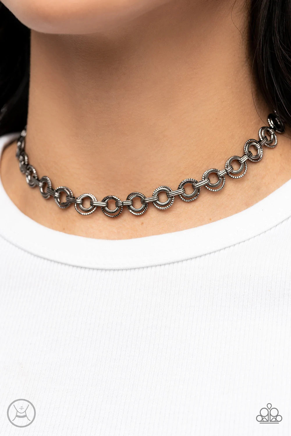 Paparazzi Accessories Grit And Grind - Black Dainty pairs of textured gunmetal hoops and rings link with pinched gunmetal fittings around the neck, resulting in a gritty vibe. Features an adjustable clasp closure. Sold as one individual choker necklace. I