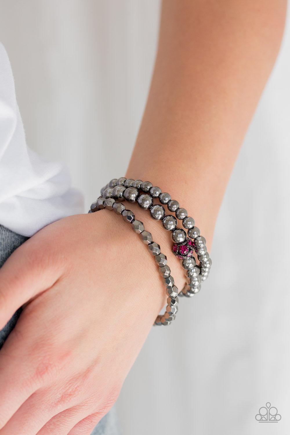 Paparazzi Accessories Noticeably Noir - Pink Mismatched gunmetal beads and pink rhinestone encrusted beads are threaded along stretchy bands for an edgy and refined look. Sold as one set of three bracelets. Jewelry