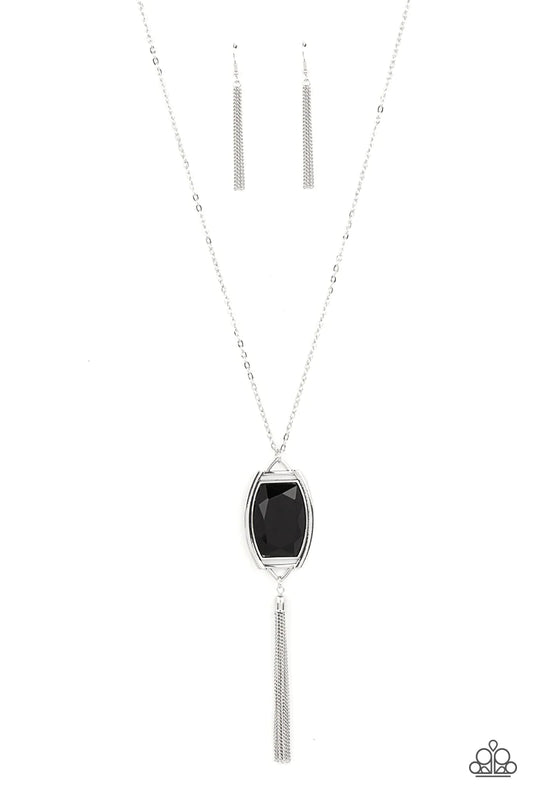 Paparazzi Accessories Timeless Talisman - Black Encased in an antiqued silver frame, an oversized black gem swings from the bottom of an ornate silver chain. A shimmery silver chain tassel swings from the bottom of the sparkly pendant, creating a regal ta