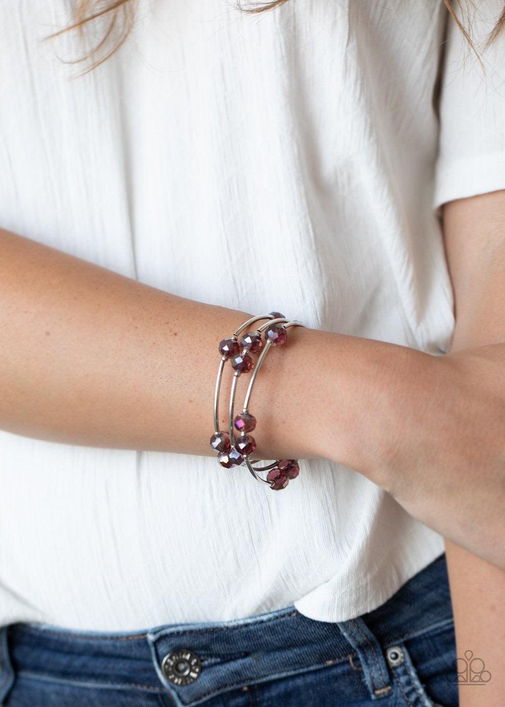 Paparazzi Accessories Dreamy Demure - Purple Glittery purple crystal-like beads, silver rods, and dainty silver beads are threaded along a coiled wire, creating a glamorous infinity wrap style bracelet around the wrist. Jewelry