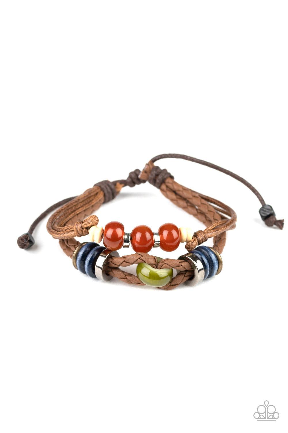 Paparazzi Accessories Uncharted Territory ~Brown A colorful collection of glassy, wooden, and metallic beads are threaded along strands of shiny twine and braided leather cording for an urban flair. Features an adjustable sliding knot closure.