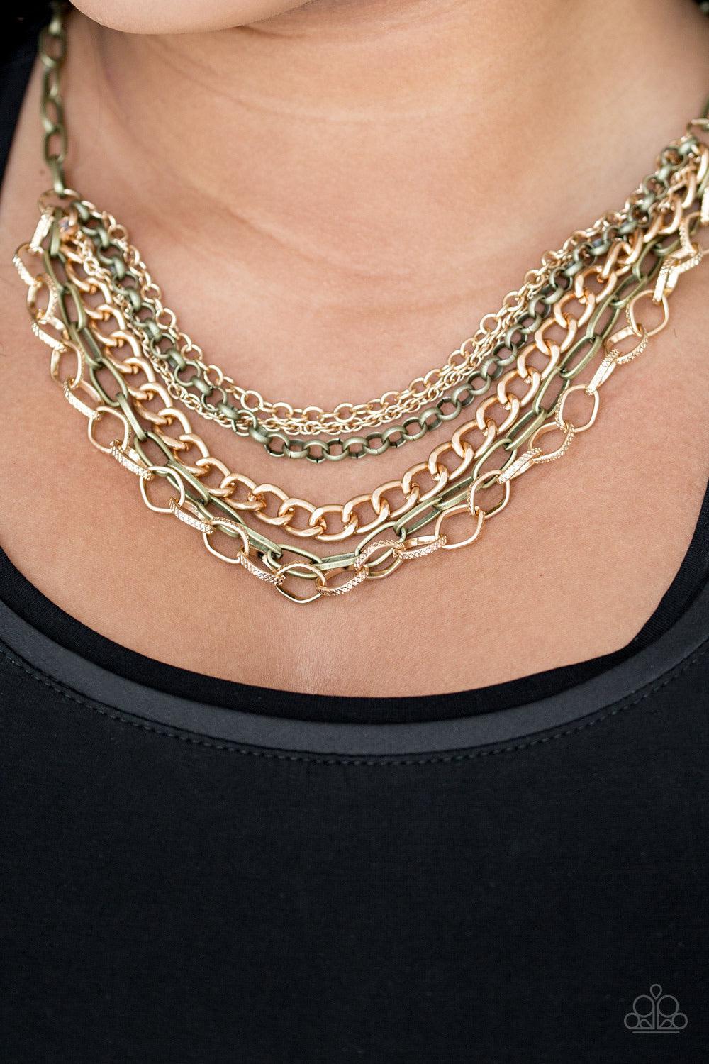 Paparazzi Accessories Word On The Street ~Brass Varying in size and shape, glistening brass and gold chains layer below the collar. Featuring smooth and textured links, the mixed metallic palette stacks into a collision of industrial shimmer for an edgy l