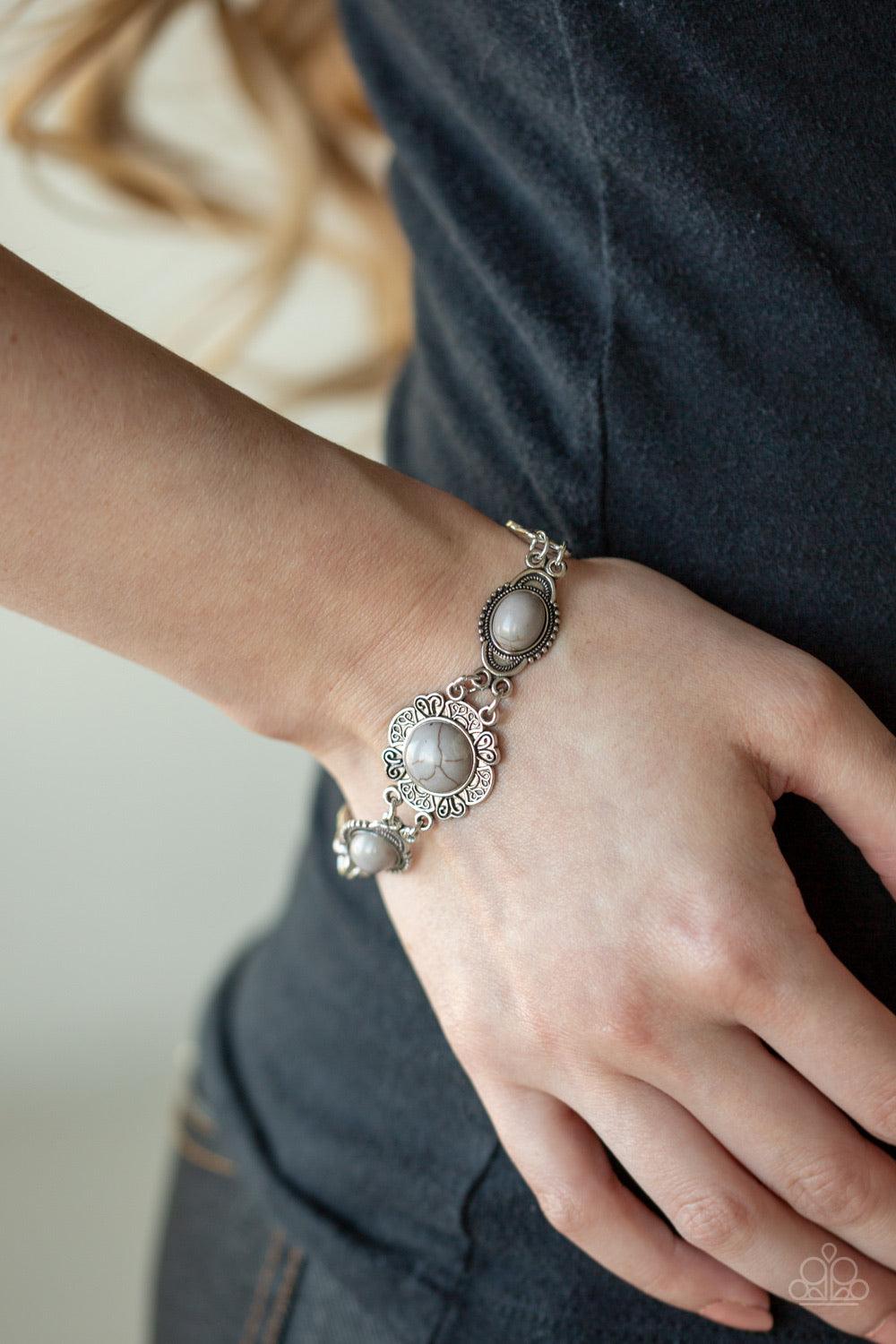 Paparazzi Accessories Serenely Southern - Silver Embossed in whimsical filigree, ornate silver frames link with a collection of neutral gray stone frames around the wrist for a seasonal flair. Features an adjustable clasp closure.Sold as one individual br