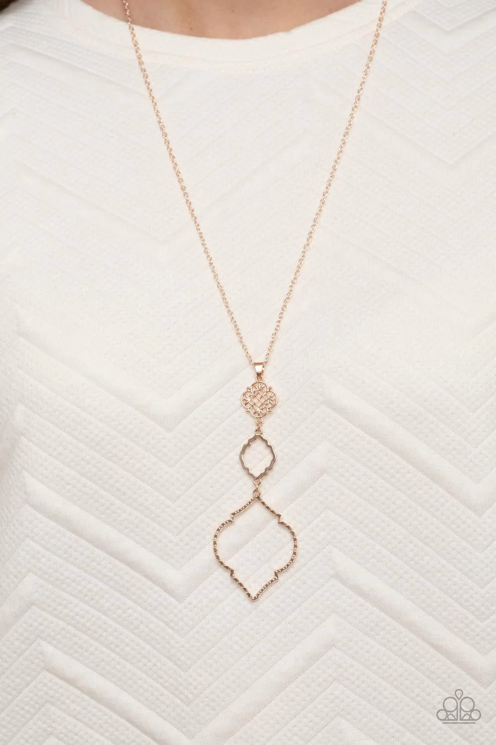 Paparazzi Accessories Marrakesh Mystery - Rose Gold Featuring mandala-like patterns, a floral lattice frame gives way to mismatched scalloped rose gold frames, creating a magnificently stacked pendant at the bottom of an extended rose gold chain. Features
