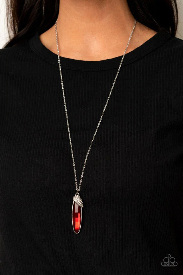 Paparazzi Accessories Spontaneous Sparkle - Red A white rhinestone encrusted silver fitting slants across the top of an oversized oval red rhinestone, creating a glamorous pendant at the bottom of a lengthened silver chain. Features an adjustable clasp cl