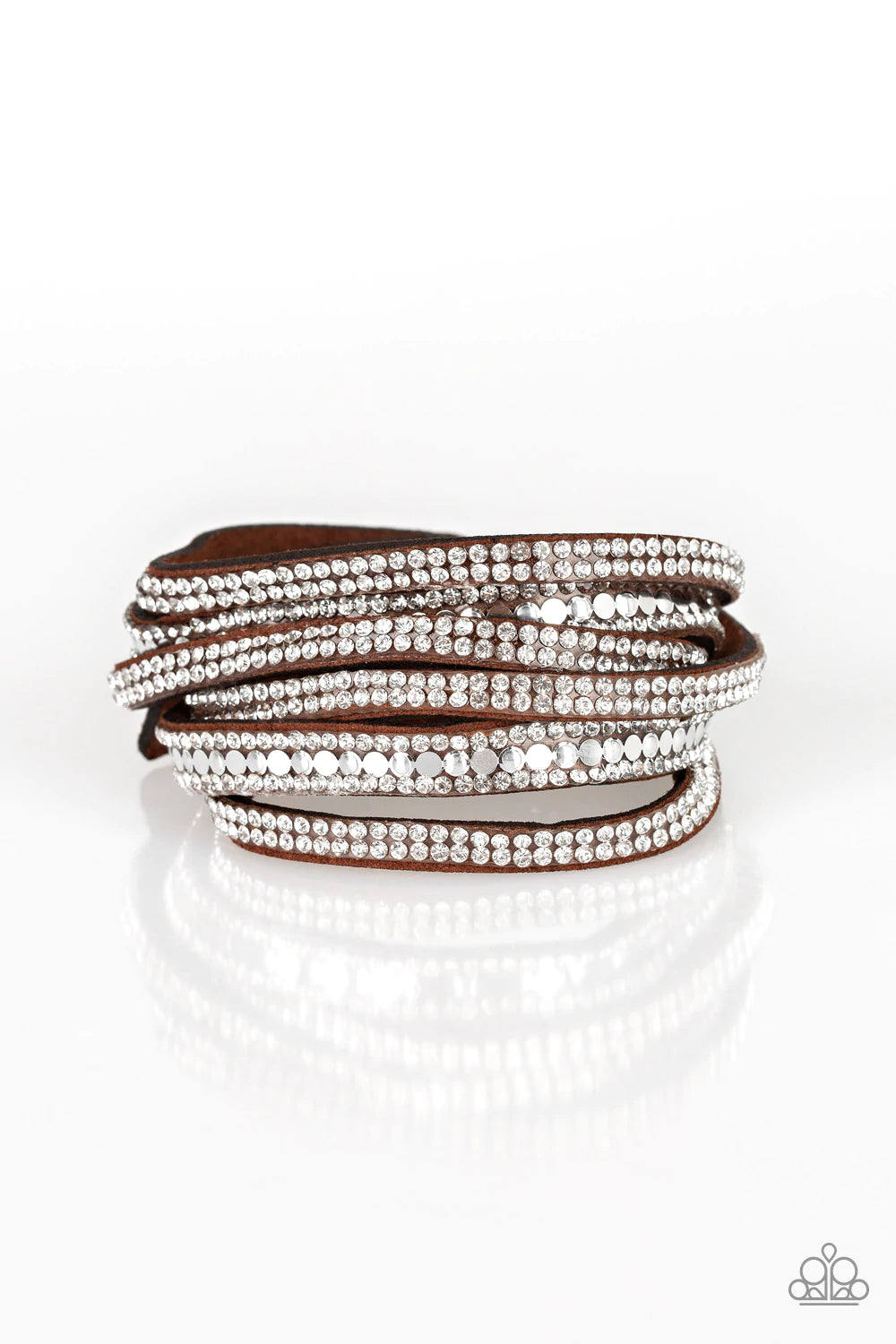Paparazzi Accessories Rock Star Attitude - Brown Encrusted in rows of glassy white rhinestones and flat silver studs, three strands of brown suede wrap around the wrist for a sassy look. The elongated band allows for a trendy double wrap around the wrist.
