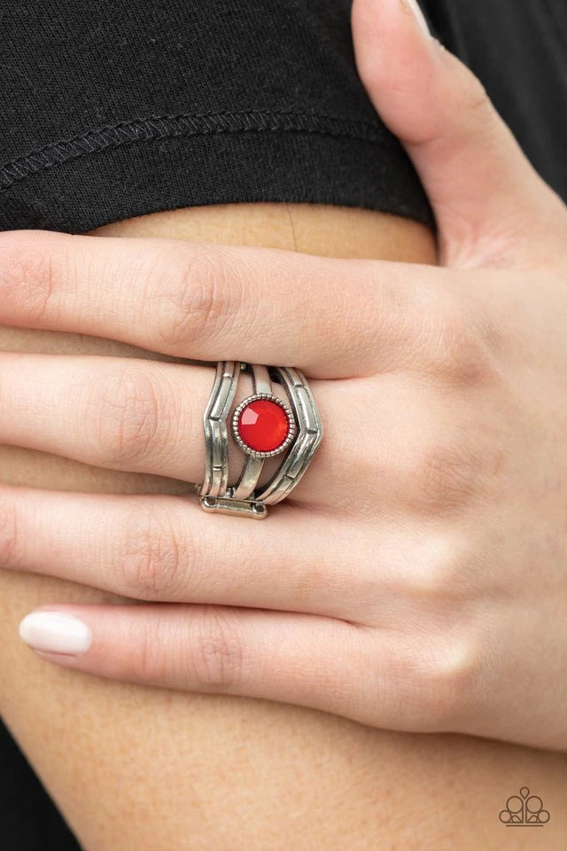 Paparazzi Accessories Celestial Collaboration - Red A faceted opaque red bead encased in a studded silver frame takes center stage on a silver band. Engraved silver chevron frames create a trendy border as they wrap around the finger. Features a stretchy
