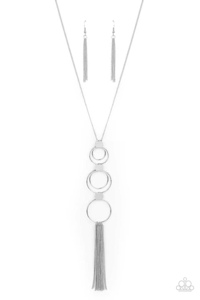 Paparazzi Accessories Join The Circle - Silver A set of concentric silver circles connected by flat silver discs swings from a lengthened silver chain. A soft silver fringe sways from the bottom ring for an elemental approach. Features an adjustable clasp