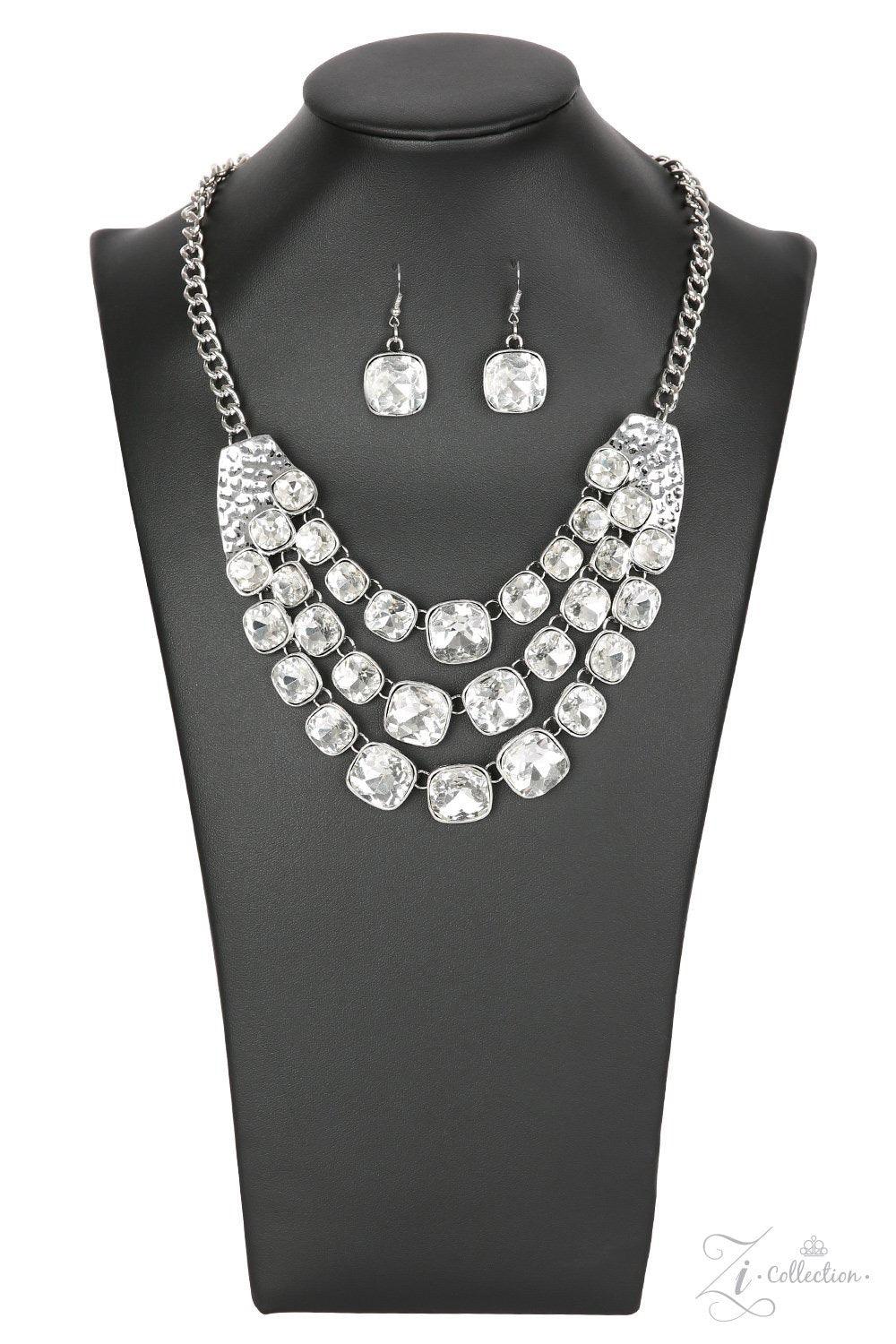Paparazzi Accessories Unstoppable Two delicately hammered silver fittings give way to three rows of sparkling white rhinestones, each encased in a sleek silver frame. The subtly rounded edges of each glittery gem add a touch of femininity to the bold desi